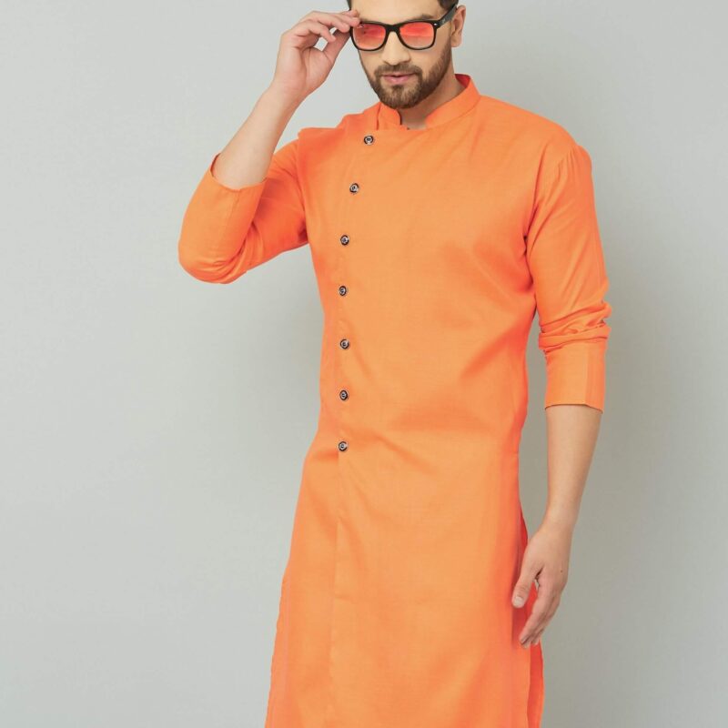 Orange cotton kurta with white pants, traditional Indian attire.